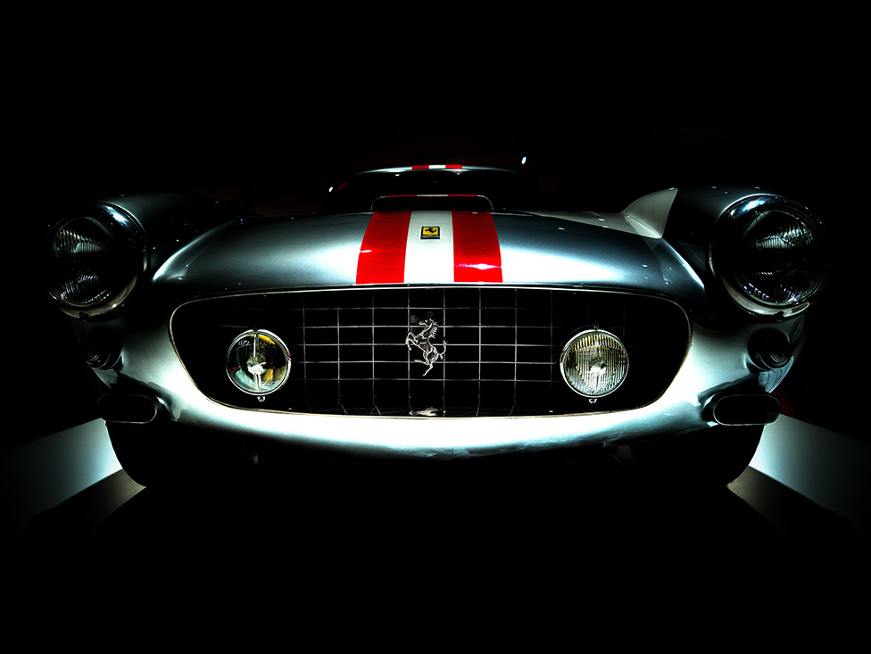 Front End Of A Classic Ferrari In A Dark Room